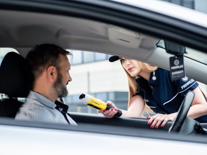 Photo by Łukasz Promiler: https://www.pexels.com/photo/police-officer-conducts-breathalyzer-test-on-driver-31154447/